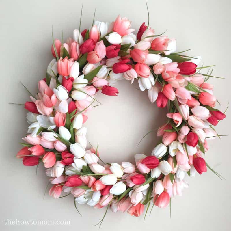Floral wreath with pink and white tulips on a light gray background
