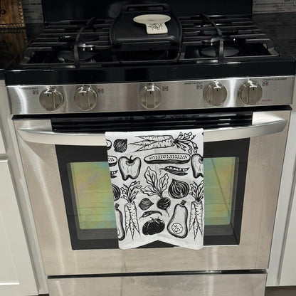 Stainless steel oven with a decorative towel on the door
