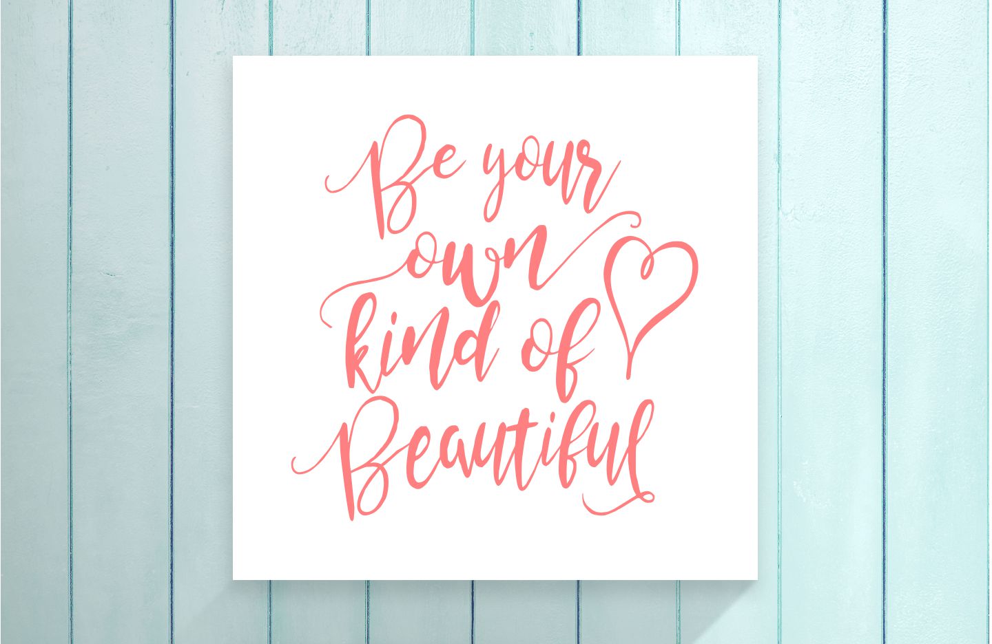Motivational poster with 'Be your own kind of beautiful' text on a light blue wooden background