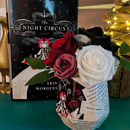 Book titled 'The Night Circus' with a bouquet of roses on top