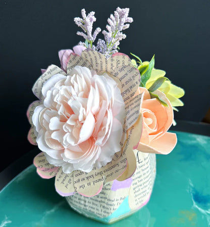 Decorative paper flower arrangement on a jar with a black background