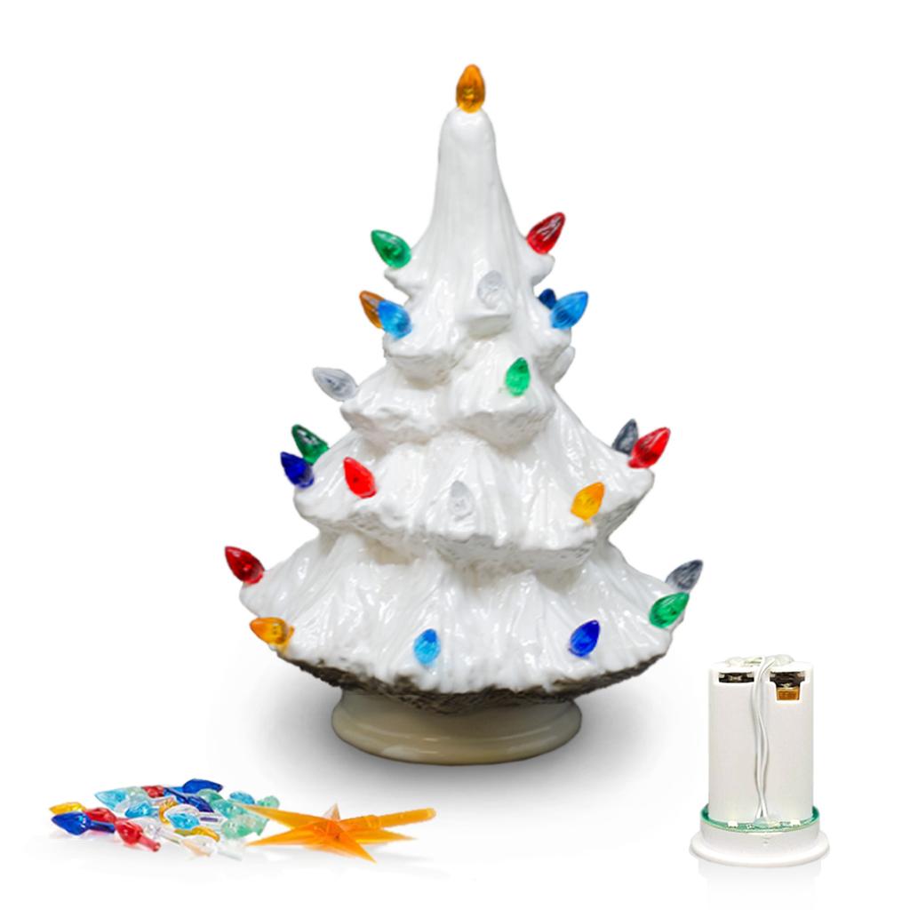 A white ceramic Christmas tree light with multicolored bulb accents, shown on a white background with its battery pack and loose bulbs.