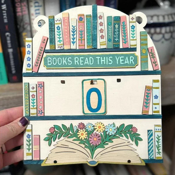 Decorative card with 'Books Read This Year' counter held by a hand