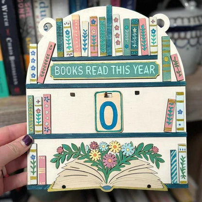 Decorative card with 'Books Read This Year' counter held by a hand