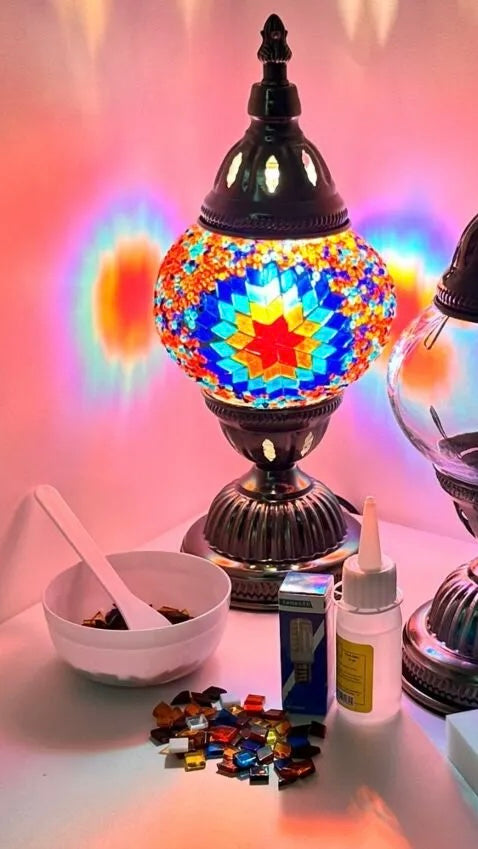 Colorful mosaic lamp with materials and tools on a table