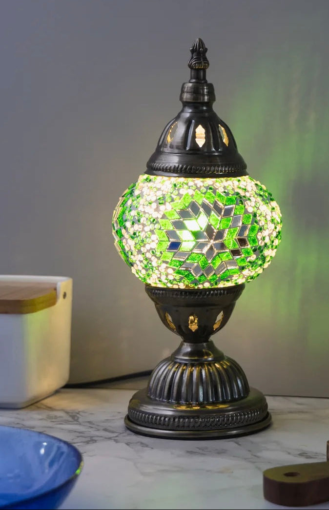 Decorative table lamp with mosaic design on a marble surface