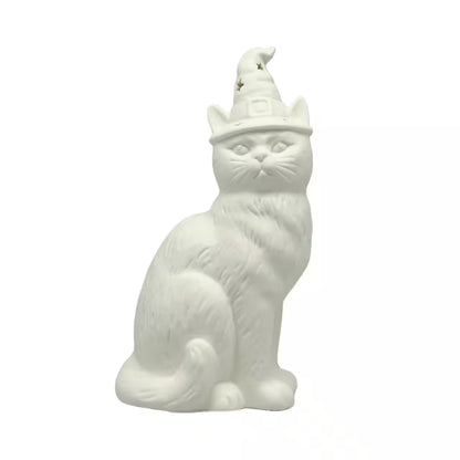 A white ceramic figurine of a sitting cat wearing a pointed wizard hat with small gold stars, set against a plain white background.