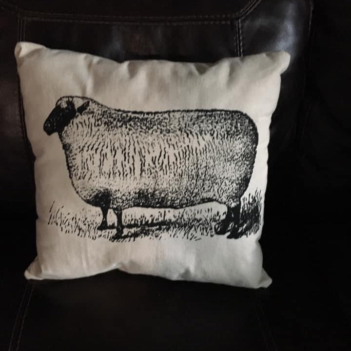 Pillow with a sheep design on a dark background