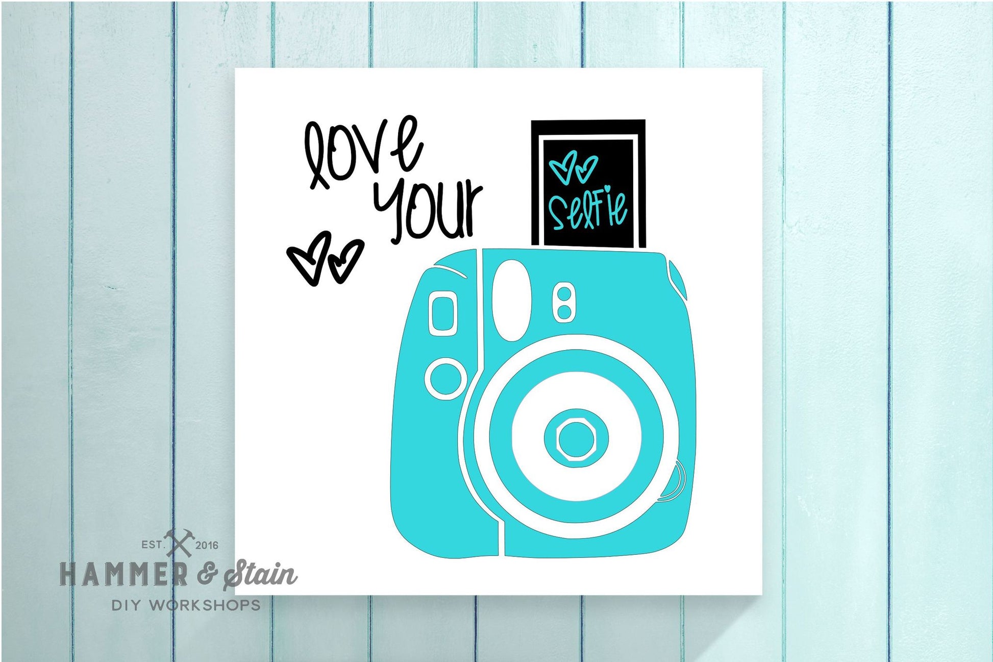 Card with a turquoise camera illustration and text on a light blue wooden background
