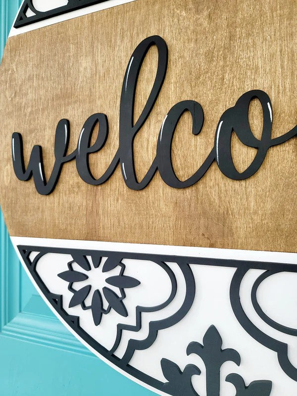 Decorative welcome sign with 'welco' on a wooden background