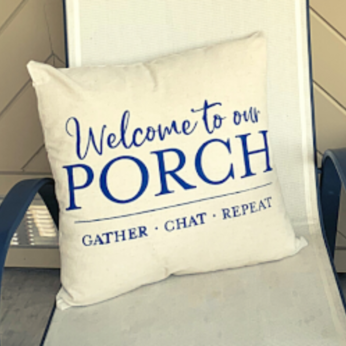 Decorative pillow with 'Welcome to our Porch' text on a chair.