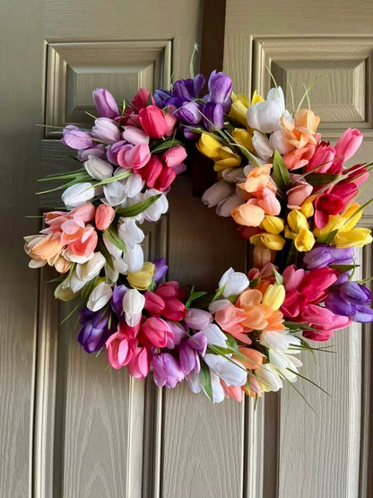 Colorful tulip wreath on a wooden door