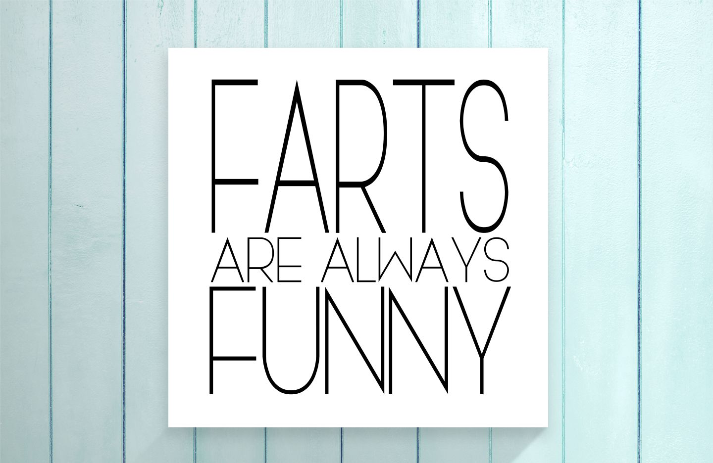 Poster with 'Farts are always funny' text on a light blue wooden background