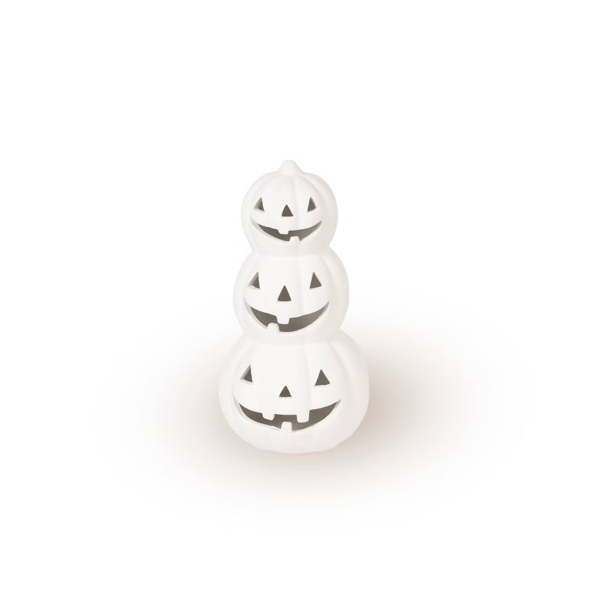 A small white decorative figurine shaped like a stack of three jack-o'-lantern pumpkins with carved facial cutouts, centered on a plain white background.